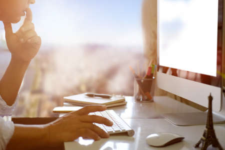 Businessman using a desktop computer with blank screen of the monitor.の写真素材