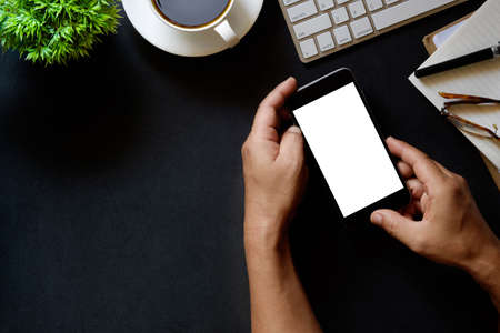 Modern dark surface office desk table with computer and cup of coffee. Hero Header Concept with Copy space.の写真素材