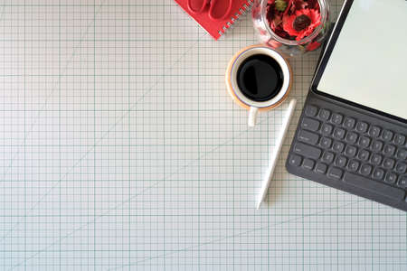 Graphic designer's workspace with a pencil tablet,  computer, color swatches and copy space on...