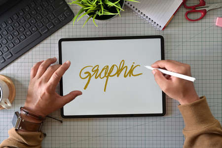 Creative graphic designer working with innovative touchscreen surface modern tablet at studio
