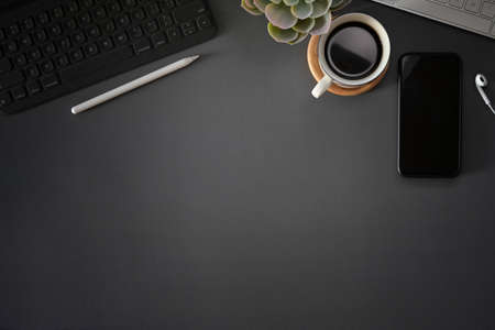 Top view dark grey workspace with office gadget and copy spaceの写真素材