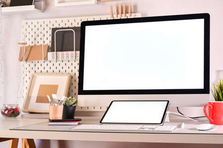 Creative designer workplace with desktop computer and drawing sketches tablet.の写真素材