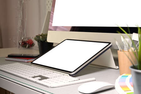 Graphic designer workplace tablet and desktop computer blank screenの写真素材