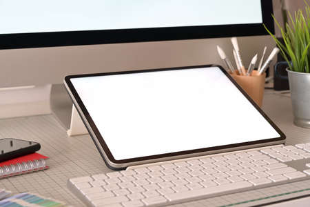 Graphic designer workplace tablet and desktop computer blank screenの写真素材