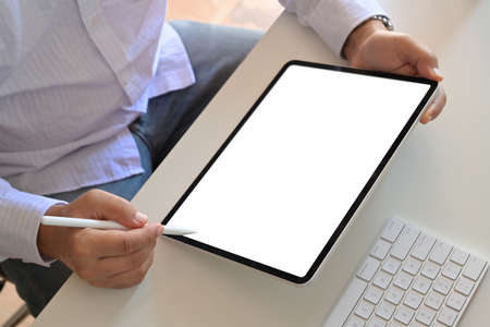 Cropped shot of an unrecognizable man using a tablet. Mockup blank screen tablet
