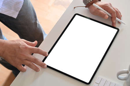 Cropped shot of an unrecognizable man using a tablet. Mockup blank screen tablet