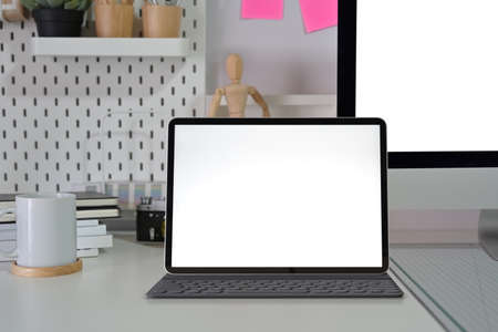 Mockup blank screen tablet with coffee on minimal office deskの写真素材
