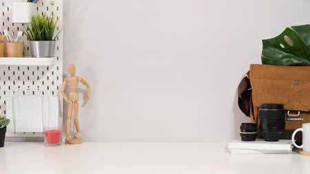 Office minimalist desk with vintage camera, stuff and copy spaceの写真素材