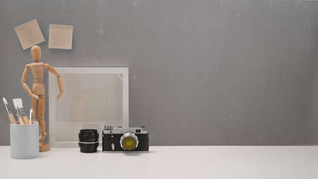 Office minimalist desk with vintage camera, stuff and copy spaceの写真素材
