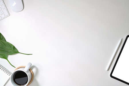 Office white desk table with computer, supplies, tablet and coffee mug. Top view with copy spaceの写真素材