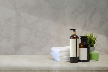 Towels and spa accessory on white marble counter tableの写真素材