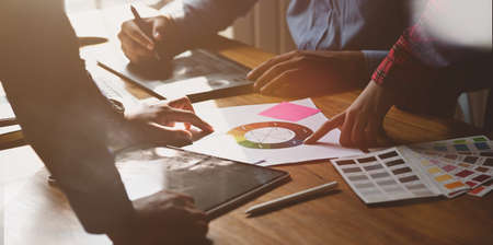 Creative designer team meeting discussion ideas on desk