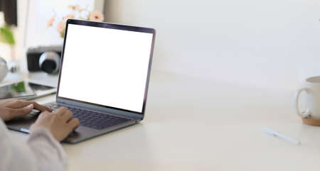 Woman hands in laptop with isolated  white screen in the room