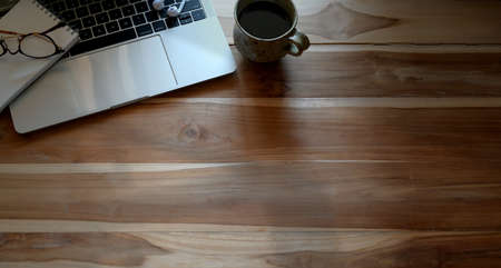 Top view shot of office desktop with laptop and copy space