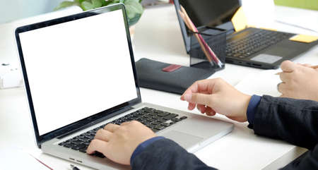 Man working with laptop mockup blank screen at table in the office