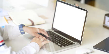 Female freelancer working with laptop. Mock up laptop with blank screen
