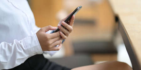 Young businesswoman using mobile smartphone in officeの写真素材