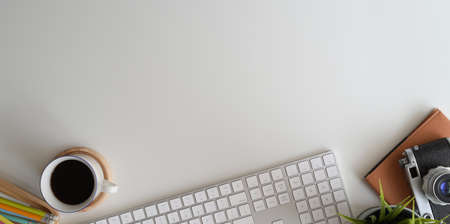 Workspace and office stuff on white desk table with copy spaceの写真素材