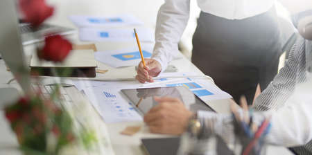 Young successful designers team brainstorming their upcoming project while working on tablet computerの写真素材