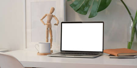 Blank screen laptop on white desk in minimal office roomの写真素材