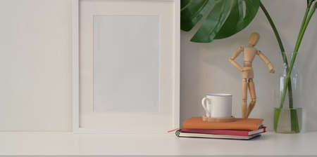 Front view of mock up frame on white wall minimal style with decorationsの写真素材