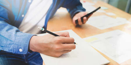 Close-up view of young male UI designer working in officeの写真素材