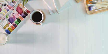 Top view of artist graphic designer workplace with white wooden tableの写真素材