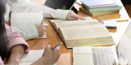 Group of teenager girls doing group studying in school libraryの写真素材