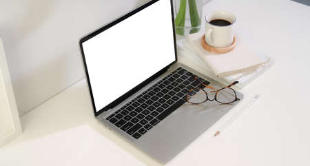 Business people's work place with blank screen laptop on table with copy spaceの写真素材