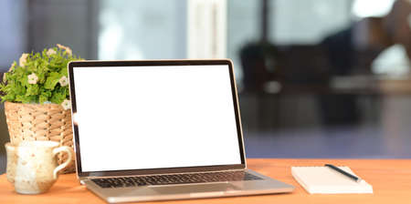 Close-up of blank screen laptop in office with blurred backgroundの写真素材