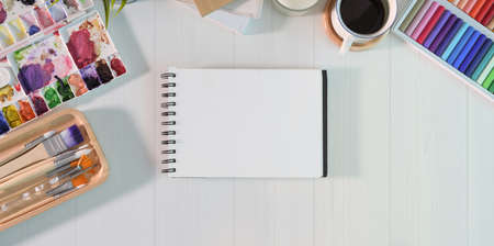 Empty sketchbook page with water colour painting tool in creative studioの写真素材