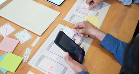 Close-up of young male UI UX designer's hand working on their projectの写真素材