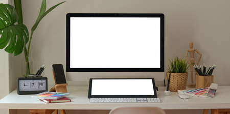 Creative designer working space with blank screen computer, tablet and decorationの写真素材