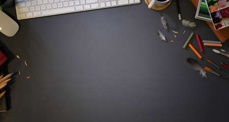 Top view of designer's stylish work place with drawing equipment with dark background