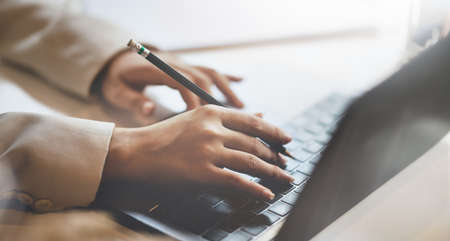 Close-up view of businessman hand's working on the strategy while typing on laptop keyboardの写真素材