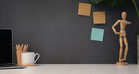 Creative workplace with copy space in modern office style with decorations and open laptopの写真素材