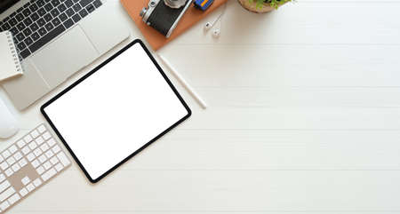 stylish minimalist workspace with blank screen laptop and office suppliesの写真素材