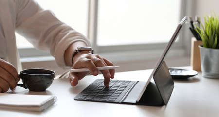 Young male graphic designer working on his project in comfortable officeの写真素材
