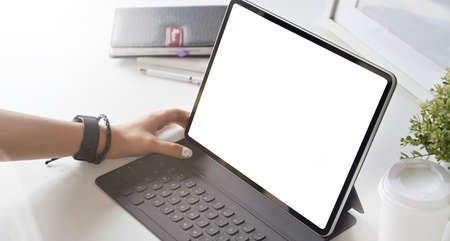 Blank screen tablet on white wooden table in modern officeの写真素材