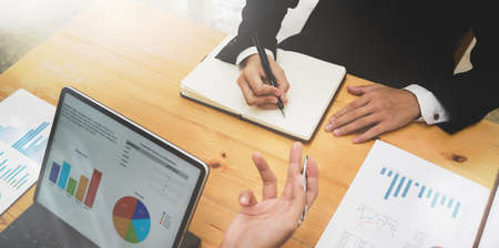 Business partner brainstorming the investment plan together in office roomの写真素材