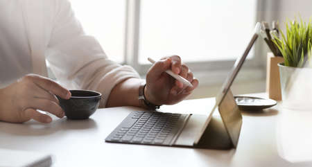 Young male graphic designer working on his project in comfortable officeの写真素材