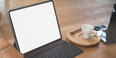 Open blank screen  laptop in comfortable workplace with coffee cup and office supplies