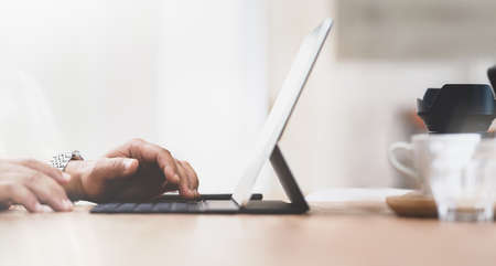Cropped view of businessman's hand working on his marketing plan with tabletの写真素材