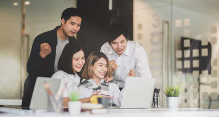 Professional business team feeling delighted after receiving good news from their successful projectsの写真素材