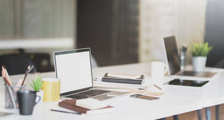 Open blank screen laptop and office supplies in modern workplaceの写真素材