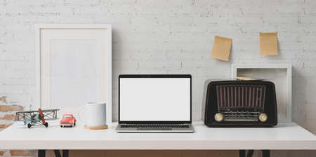Contemporary workplace concept : blank screen laptop computer and office suppliesの写真素材