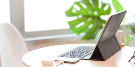 Minimal comfortable workplace with tablet and office suppliesの写真素材