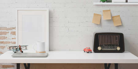 Vintage freelancer workplace with mock up frame, copy space and vintage retro radioの写真素材