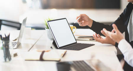 Successful businessman exchanging the idea for next startup project with blank screen tabletの写真素材