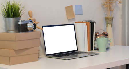 Professional photographer's comfortable workplace with open blank screen smartphoneの写真素材